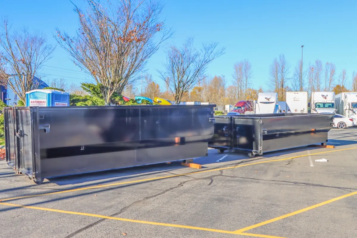 Professional dumpster rental service with roll-off container on residential driveway in Northampton